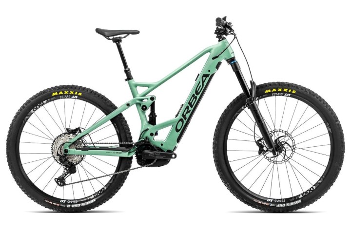 A mint green mountain bike with a sturdy frame and large tires.