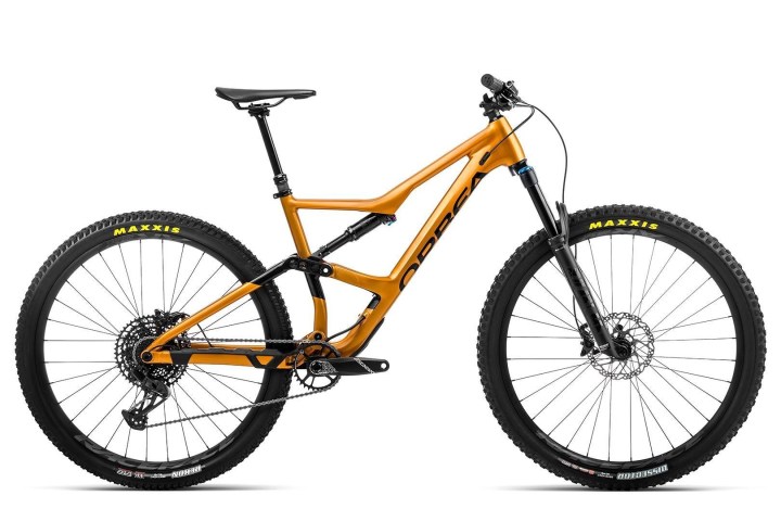 Orange mountain bike with black tires on a white background.